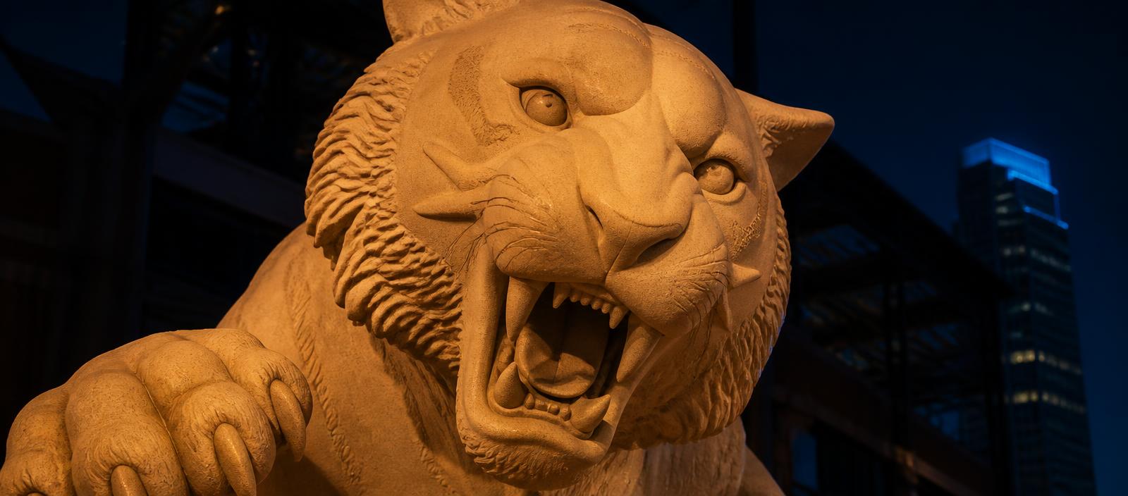 Cropped close-up of a Comerica Park tiger statue at dusk in Detroit